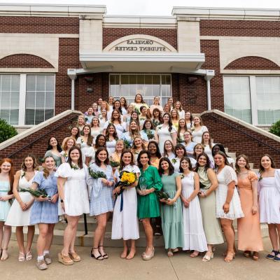 Participants in ETBU's 77th annual Senior Girl Call-Out stand on the back steps of Ornelas Student Center for a group photo