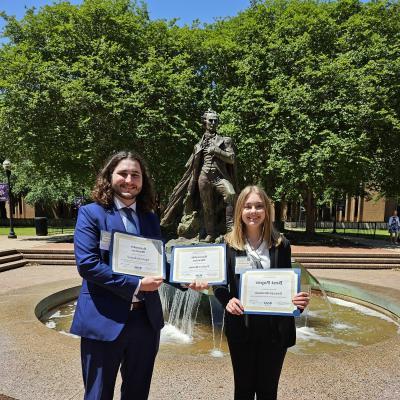 Two students hold awards received at the East Texas Regional Phi Alpha Theta Conference 2024